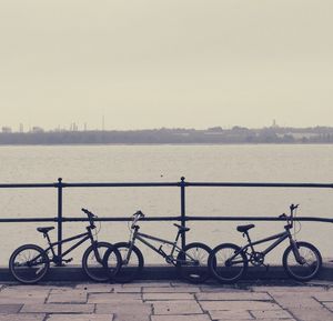 Bicycle parked by railing