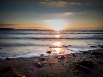 Scenic view of beach against sky during sunset