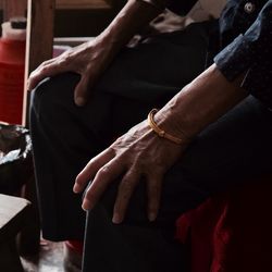 Midsection of couple holding hands