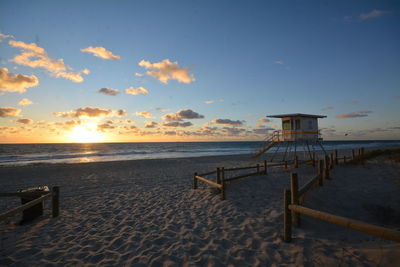 Scenic view of beach against sky during sunset