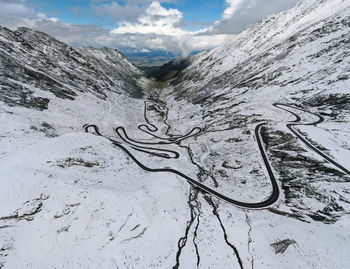 High angle view of snowcapped mountains against sky