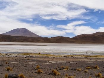 Scenic view of lake against cloudy sky