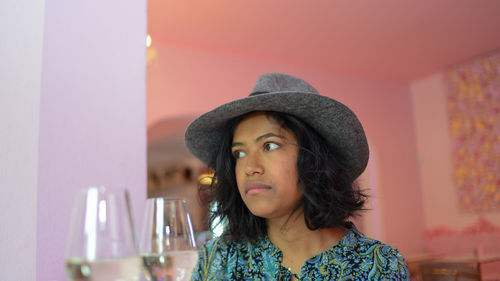 Woman wearing hat at home