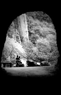 Close-up of woman sitting on rock in cave