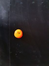 Close-up of orange slice against black background