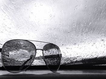 Close-up of sunglasses on wet glass