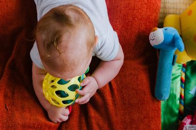 High angle view of boy playing with toy