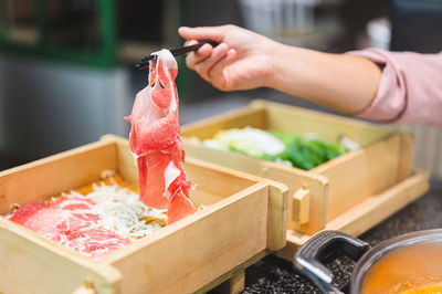 Cropped hand of person preparing food