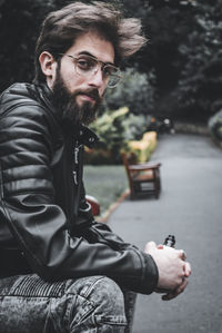 Portrait of young man sitting outdoors