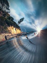 Group of people on land against the sky