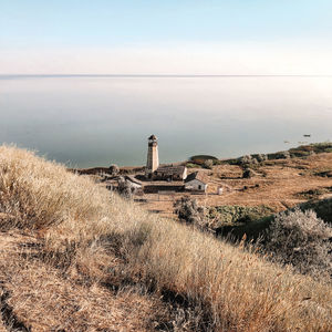 Scenic view of sea and buildings against sky