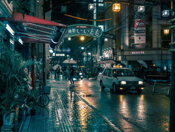 Cars on wet street at night