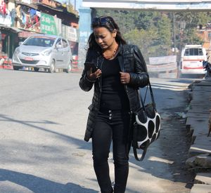 Young woman using mobile phone in city