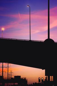 Low angle view of silhouette street against sky at sunset