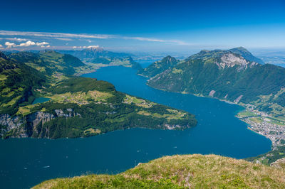 Scenic view of lake and mountains against blue sky