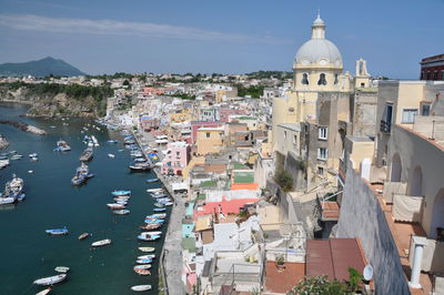 High angle view of townscape by sea against sky