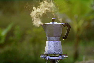 Antique coffee pot on the gas stove for camping when the sun rises in the morning.