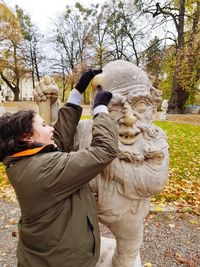 Statue of people in park during winter