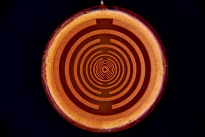 Low angle view of illuminated light bulb against black background