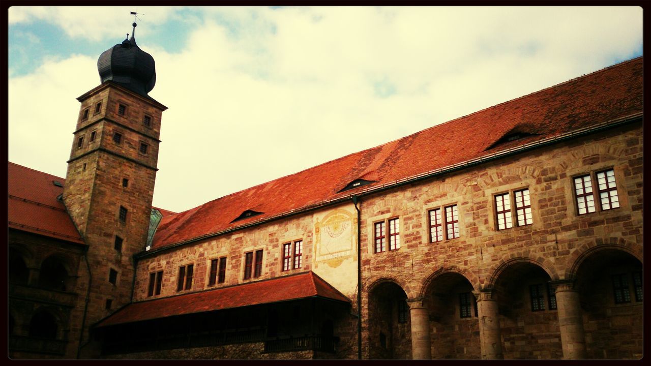 architecture, building exterior, built structure, sky, low angle view, window, arch, cloud - sky, cloud, facade, history, building, old, outdoors, residential structure, day, cloudy, residential building, city, no people