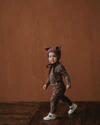 Toddler baby girl in funny hat with ears having fun