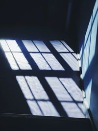Low angle view of window shadows on blue floor 