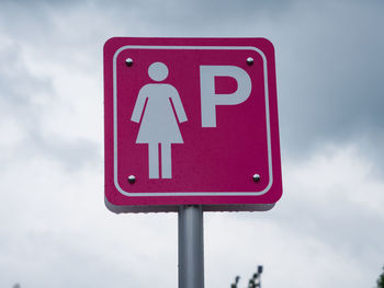 Low angle view of road sign against sky