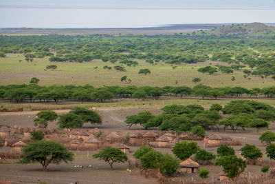 Masai village at mount ol doinyo lengai with lake natron in the background in ngorongoro, tanzania