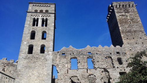 Low angle view of historical building against blue sky