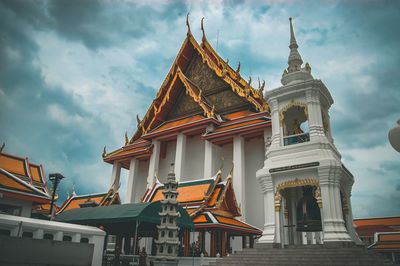 Low angle view of temple building against cloudy sky