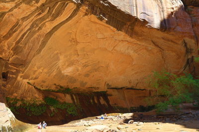 People on rock formations in cave