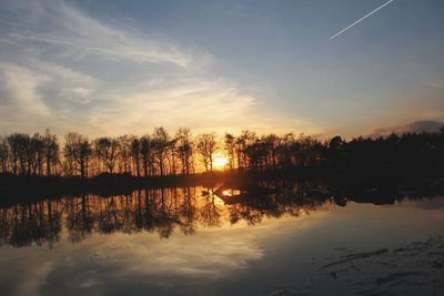 Scenic view of lake against sky during sunset