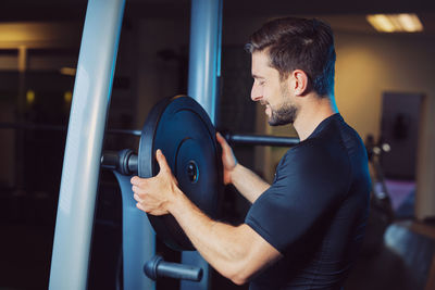 Side view of man exercising in gym