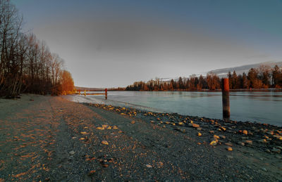 Scenic view of lake against sky during winter