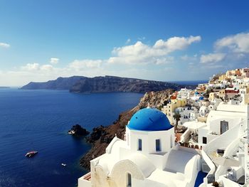 High angle view of buildings by sea against sky