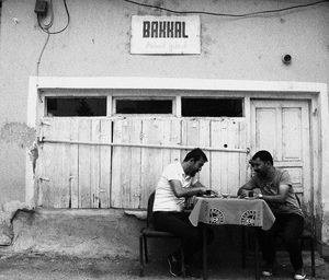 People sitting in front of building