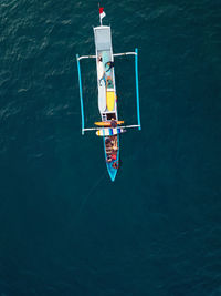 Aerial view of surfers and boat in the ocean, lombok, indonesia