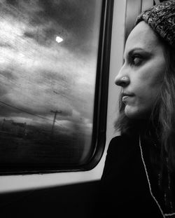 Portrait of woman looking through train window