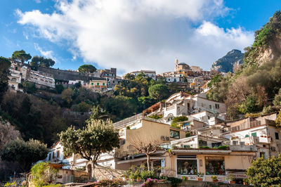 Buildings in town against sky