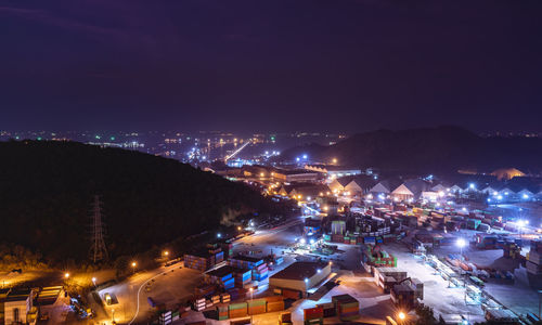 High angle view of illuminated buildings in city at night