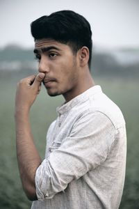 Young man smoking cigarette