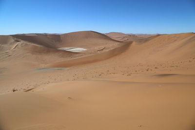 Scenic view of desert against clear sky