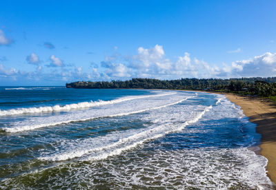 Aerial panoramic image at sunrise off the coast over hanalei bay and waioli beach park on kauai