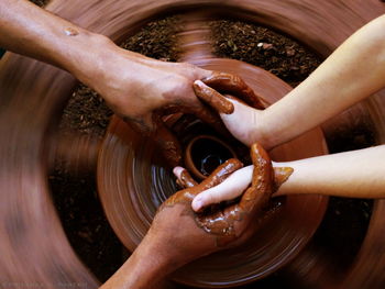 Cropped image of people making pottery