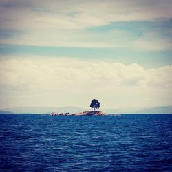 Scenic view of sea against cloudy sky