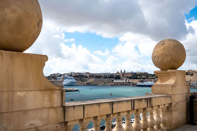 Panoramic view of sea and buildings against sky