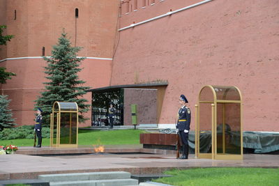 Man sitting on street against buildings in city