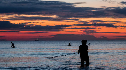 A fisherman is fishing at sunset on koh rong, cambodia