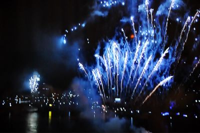 Firework display in city at night