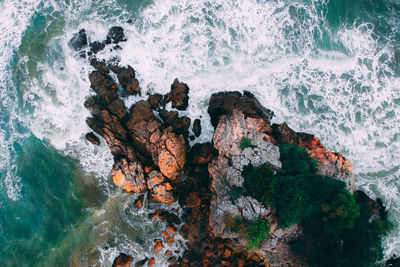 Aerial view of rocks in sea